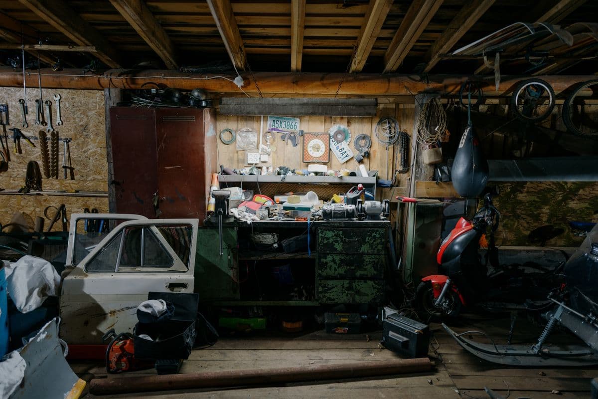 A cluttered garage interior with tools and workbench