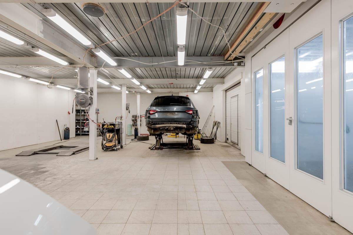 A well-lit garage with a car on a lift