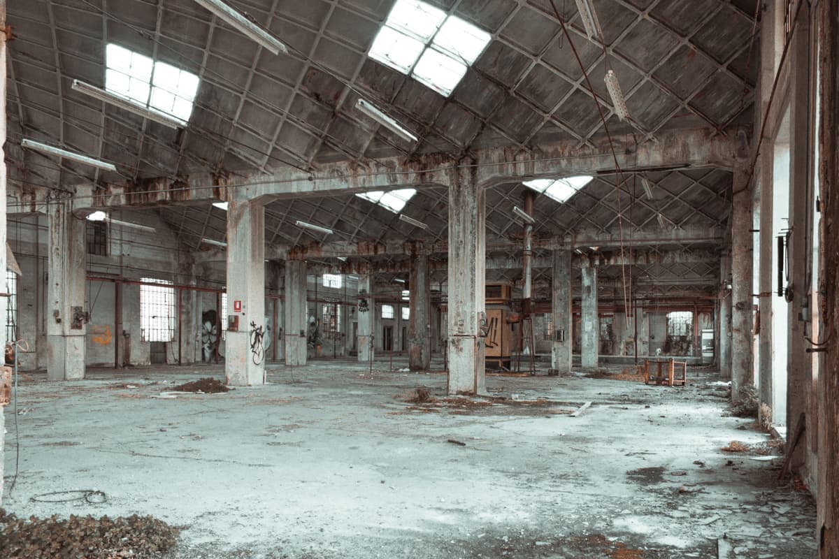 An abandoned warehouse interior with columns