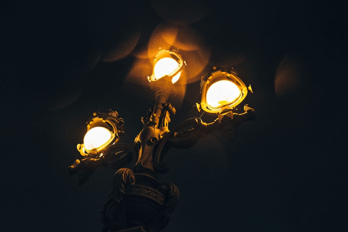 A vintage street lamp glowing at night