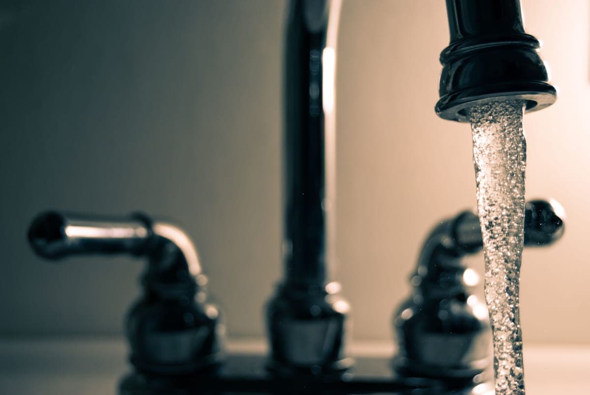 Water flowing from a steel faucet