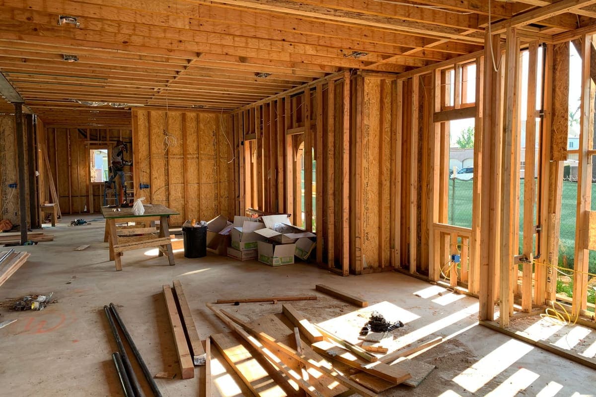 A sunlit interior space with exposed wooden framing
