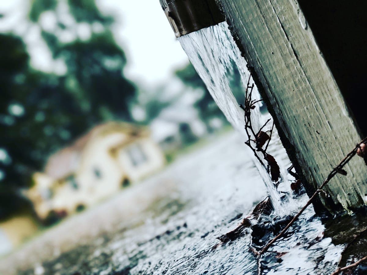 Rainwater flowing from a gutter during a storm