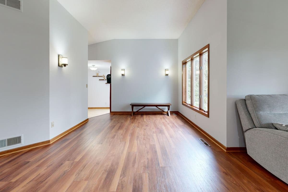 A bright minimalist living room with wooden floors
