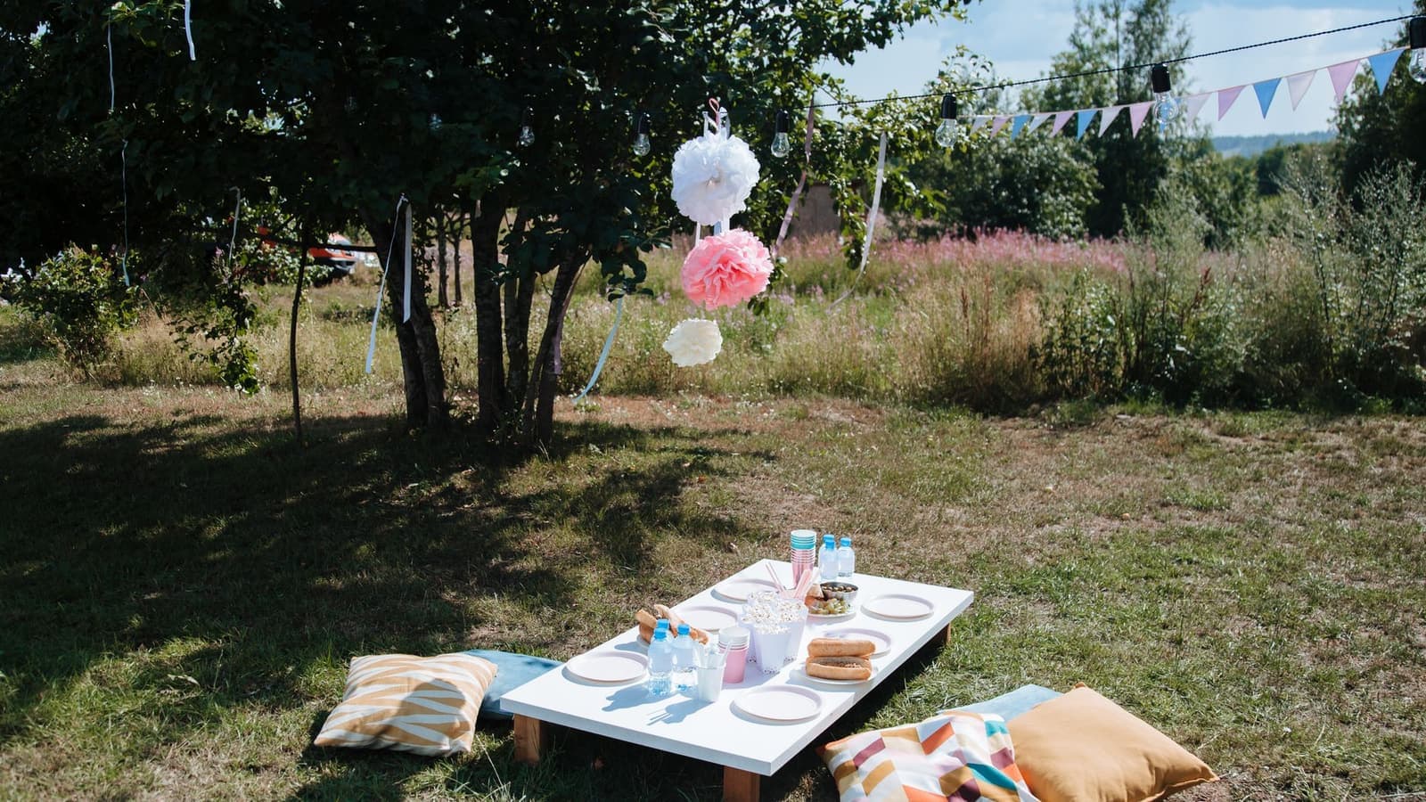 A picnic laid out on a blanket in a grassy park