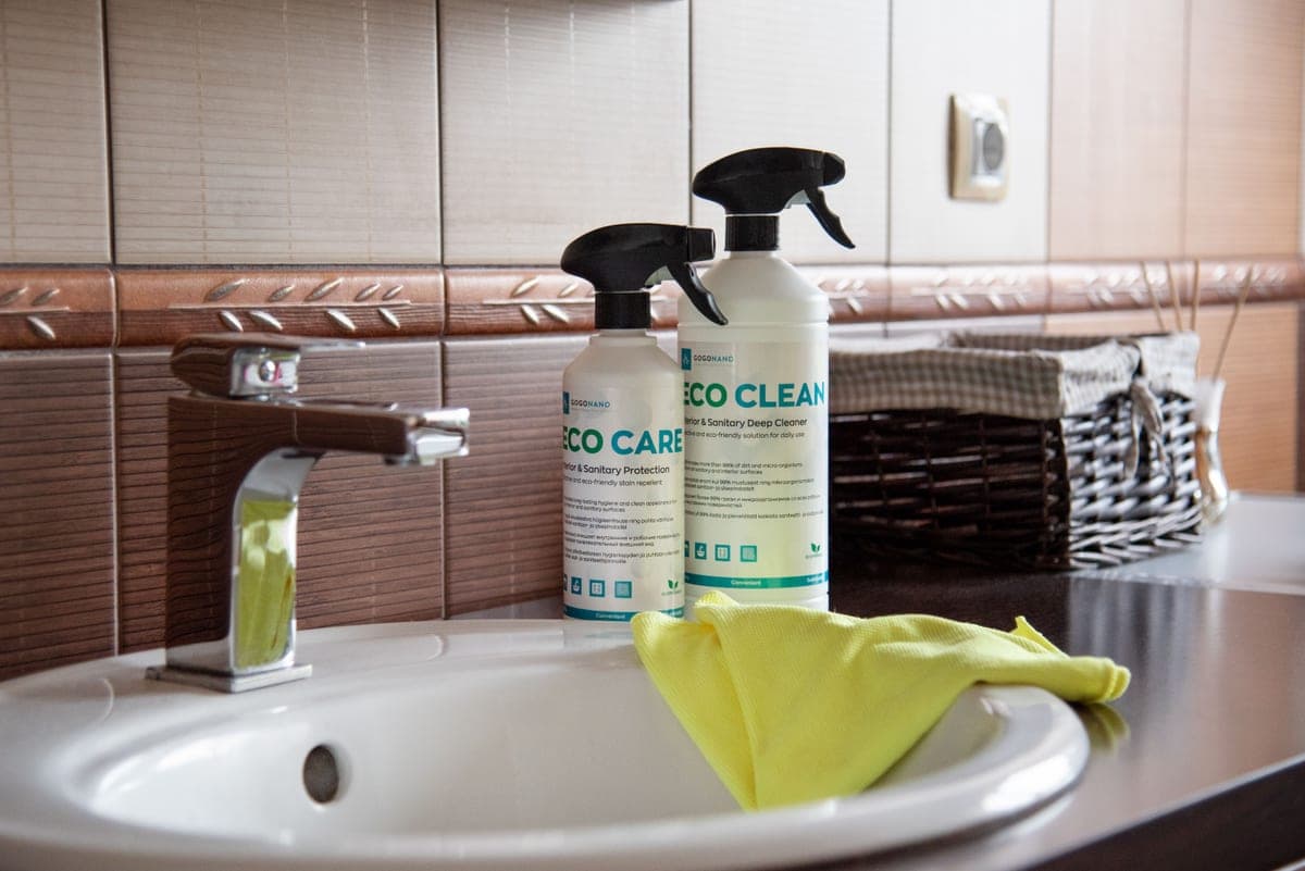 Eco-friendly cleaning products displayed on a bathroom sink