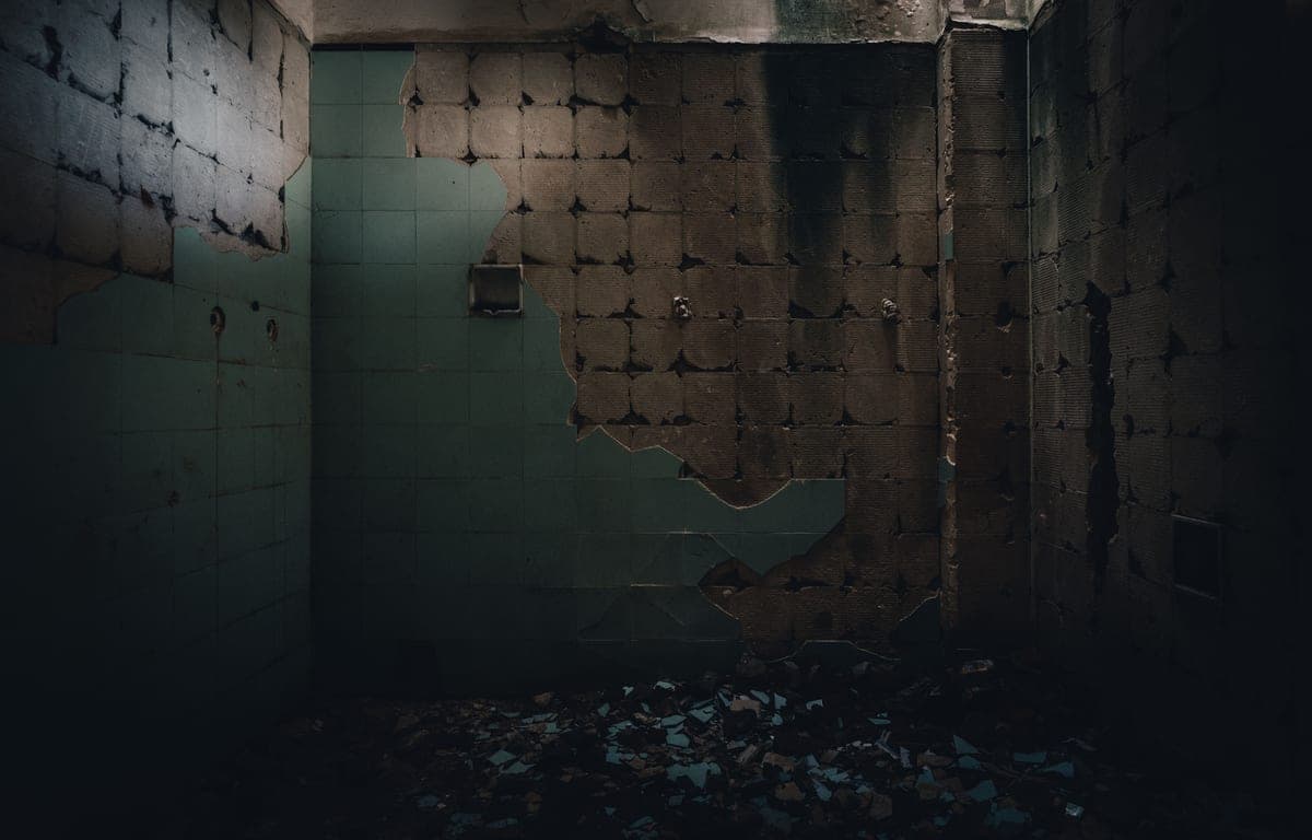 A dark, decaying room interior