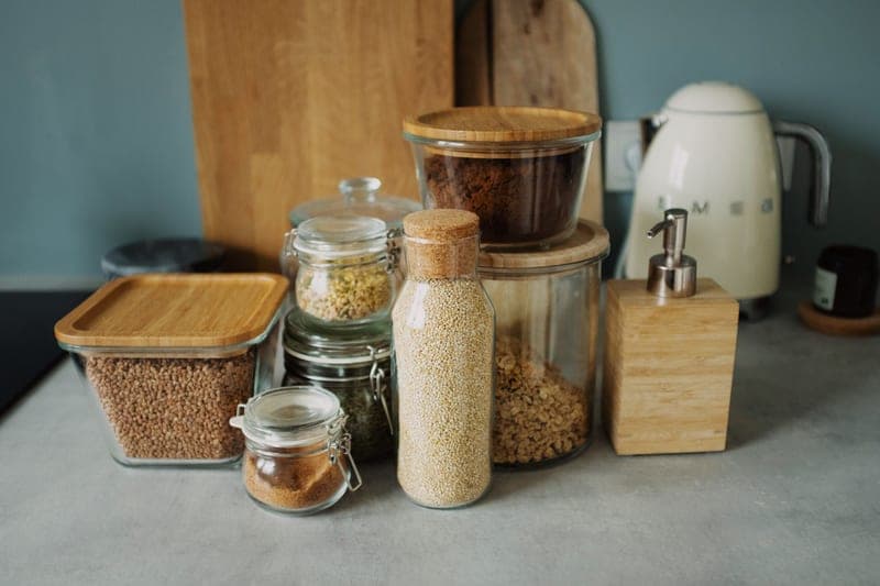 Glass storage jars and a kettle on a kitchen counter